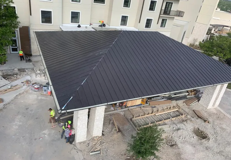 Metal roofing installation team working on a commercial building in Campbell